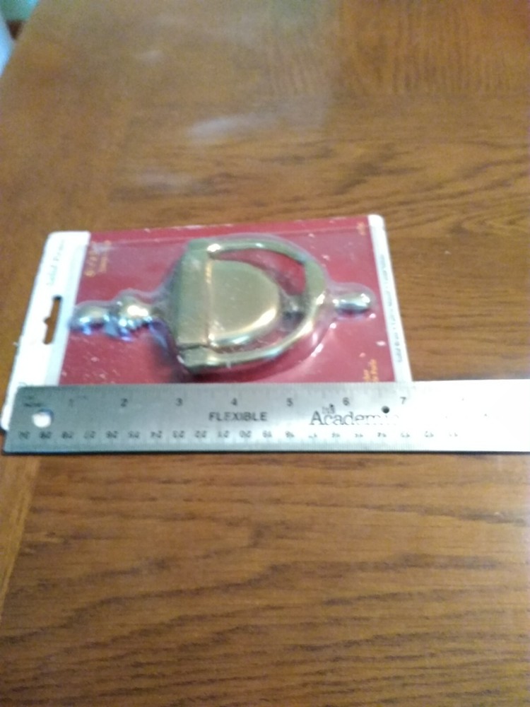 Brass Door Knocker. Unopened, but packaging rough. Solid.