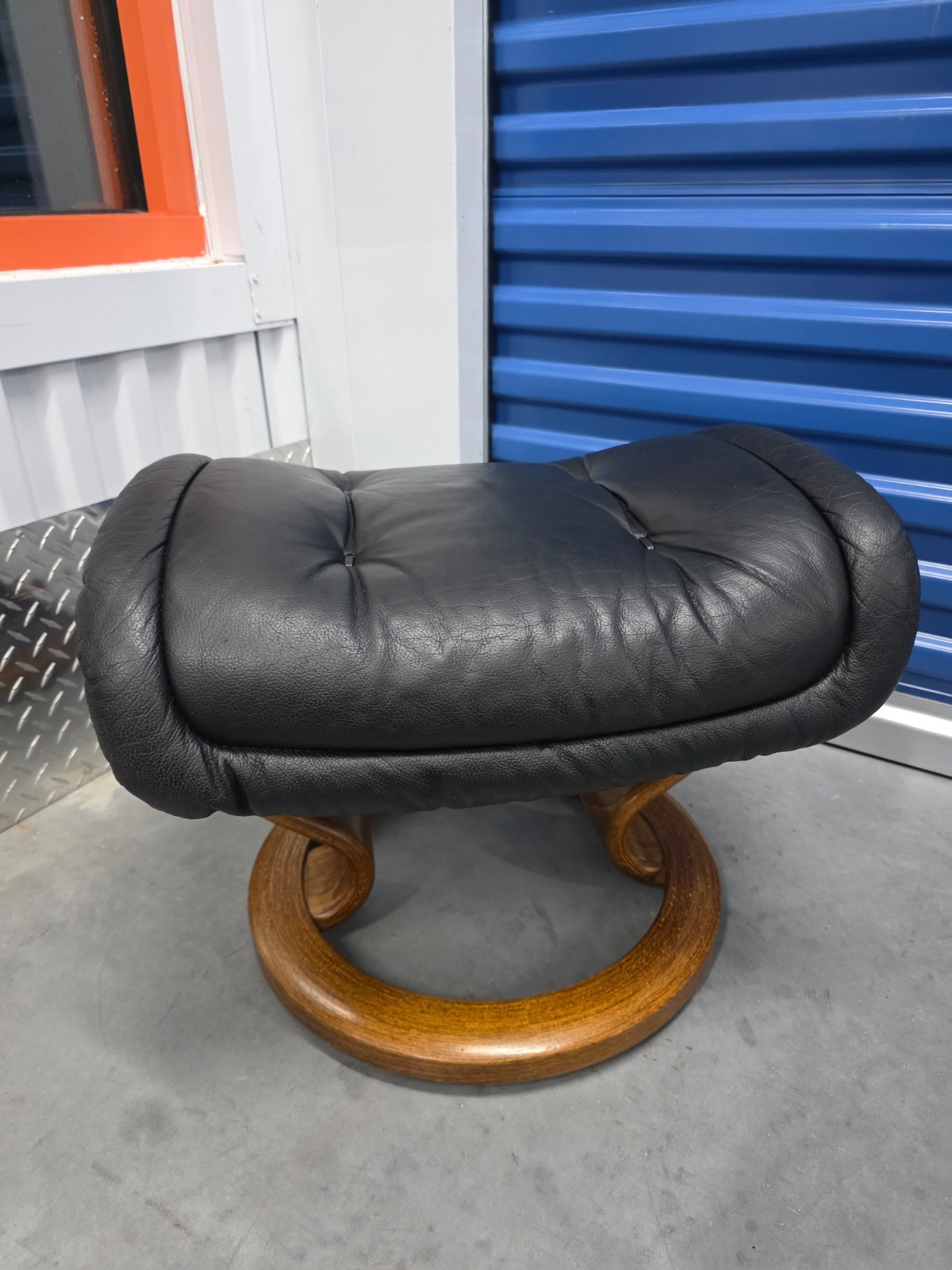 Ekornes Stressless Black Colored Leather Ottoman | Teak Stained Wood Base
