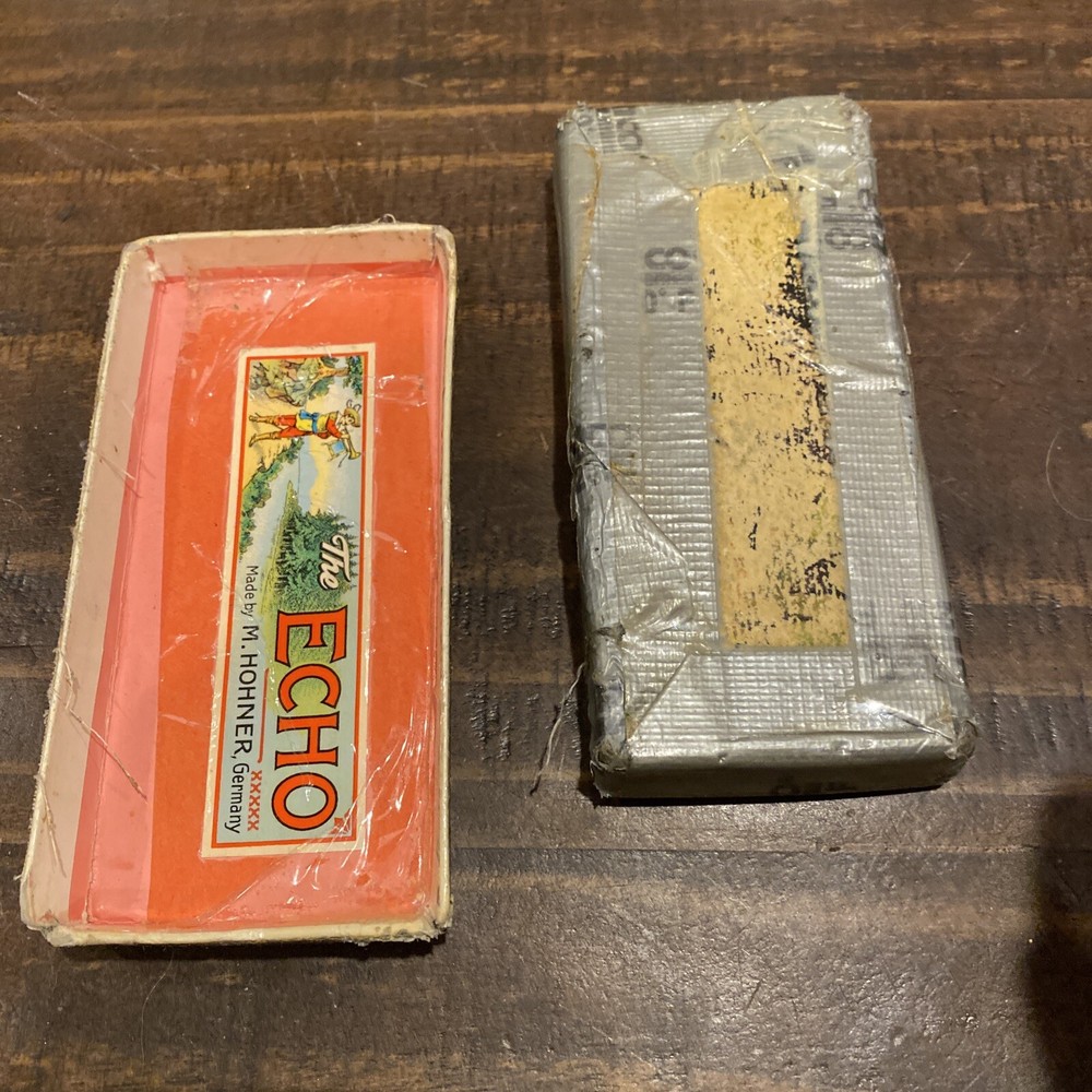 two M Hohner Echo harmonicas with rough boxes dofferent styles