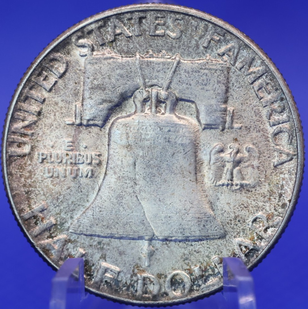 1952 About Uncirculated toned 90% silver Franklin half dollar.