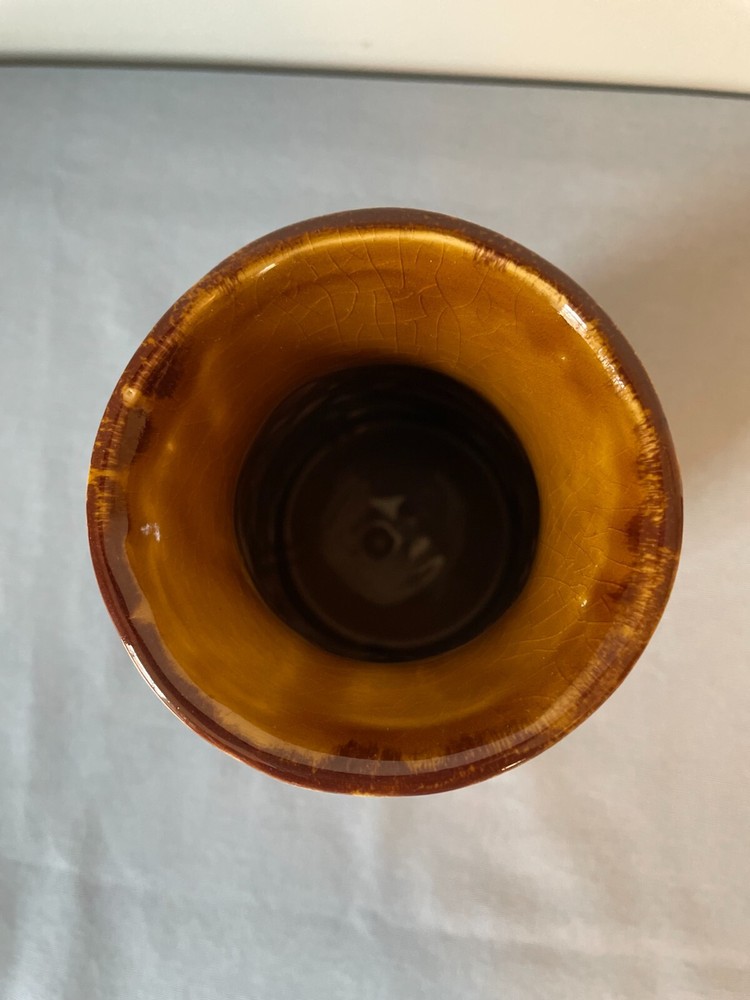 Handmade brown ceramic vase with leaves