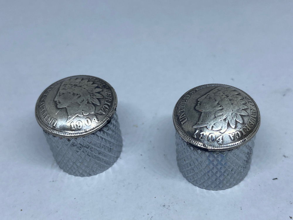 Silver toned Indian penny guitar knobs with knurled sides.