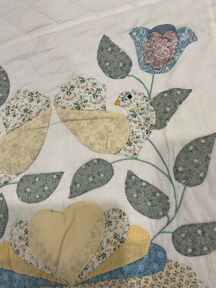 Vintage handmade quilt with birds
