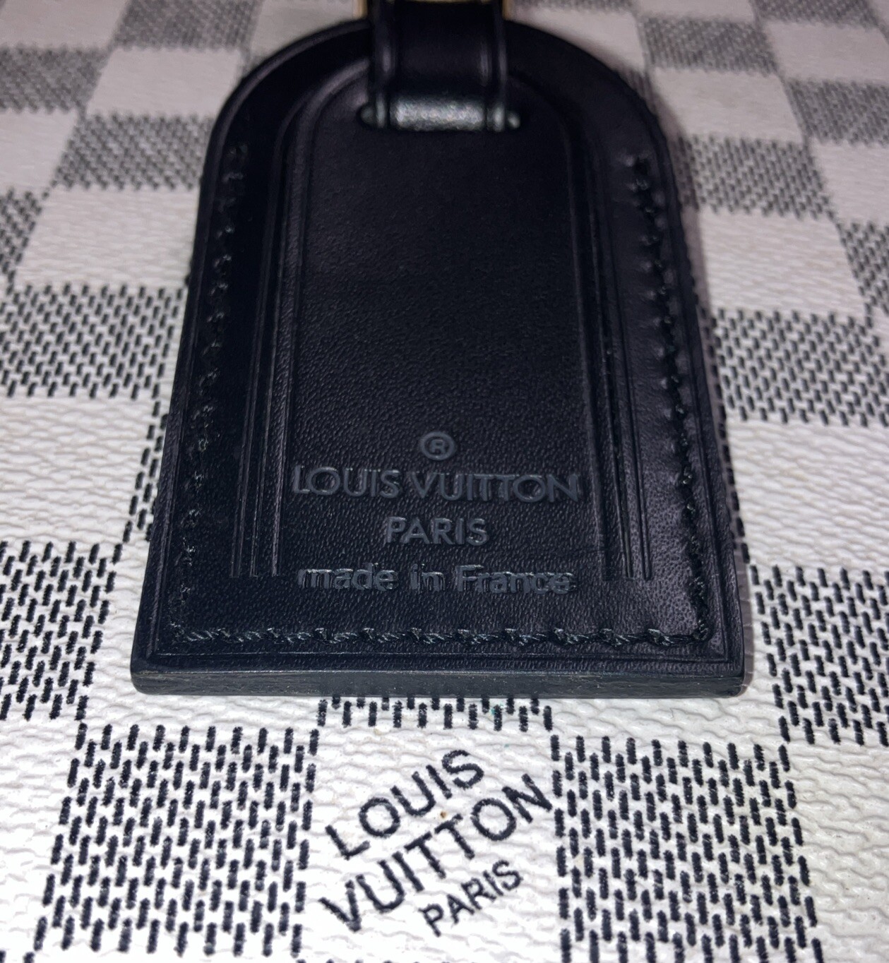 Authentic Louis Vuitton small Black W/ Gold Hardware name tag.