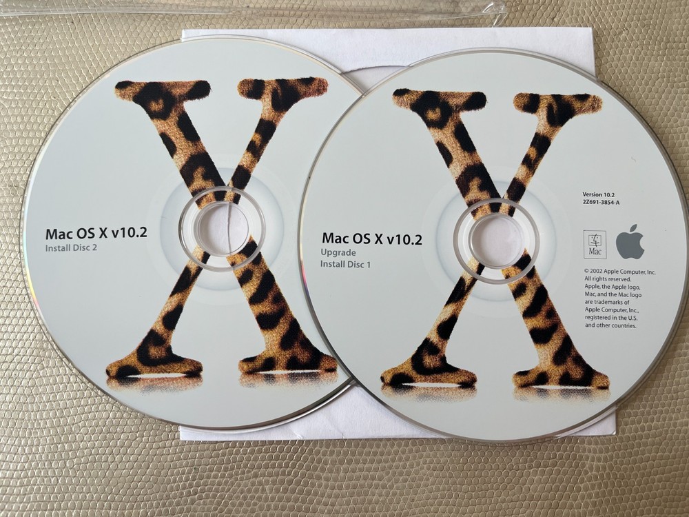 Mac OS X 10.2 Jaguar install discs + developer tools disc and Mac OS X manual