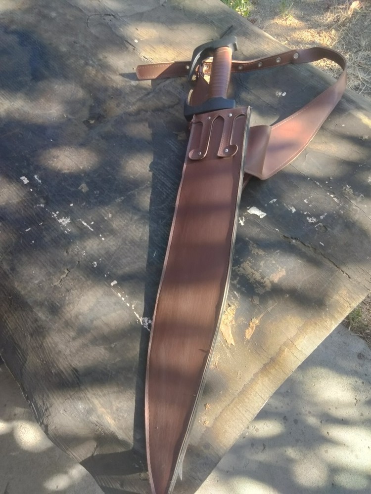 Unsharpened sword with carrying sheath and adjustable shoulder strap