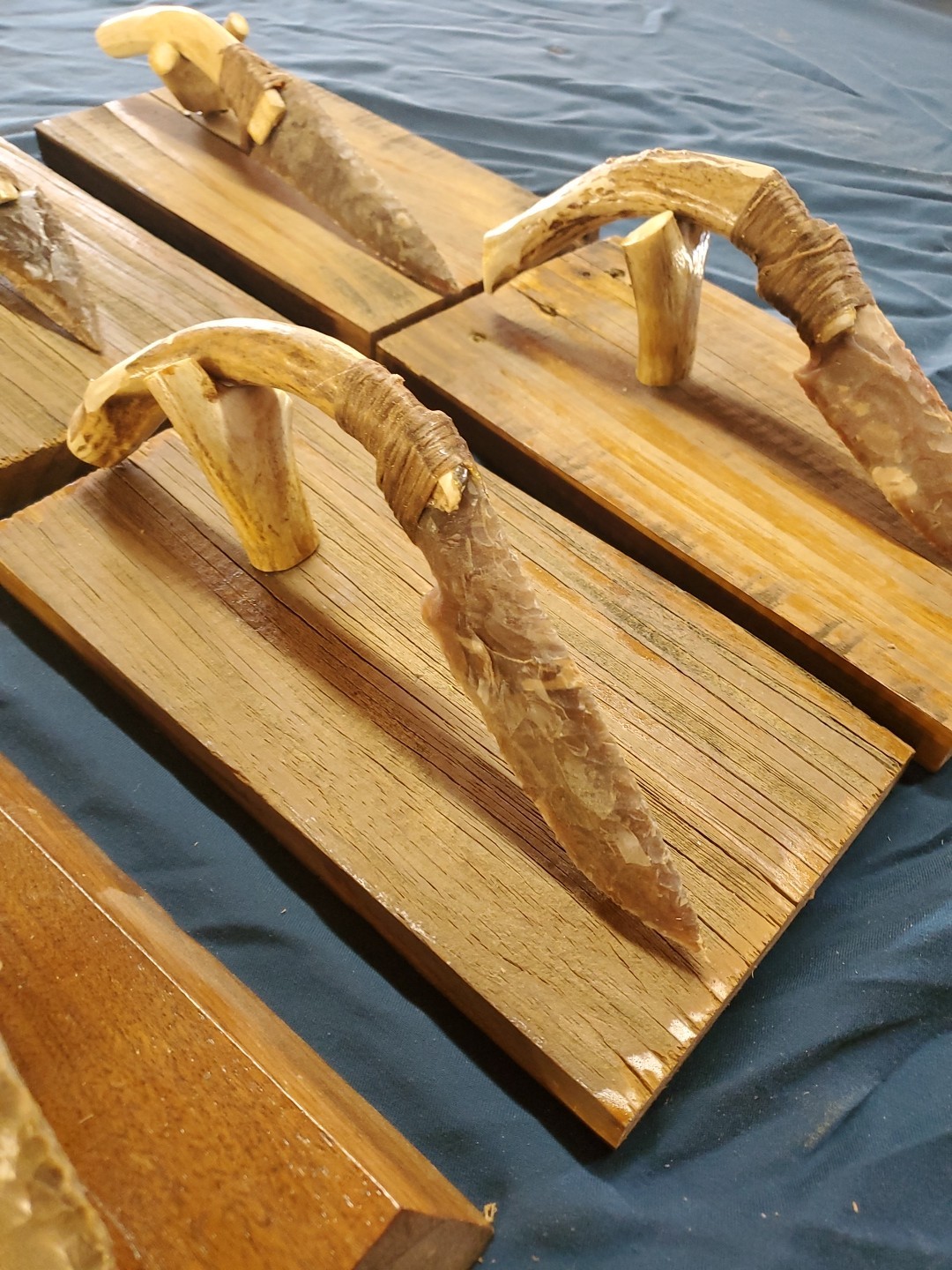 Flint Knapped Stone Arrowhead Blade Knife with Deer Antler Handle on Wood Stand