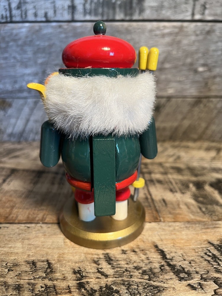 Vintage Christmas Nutcracker Holding Skies