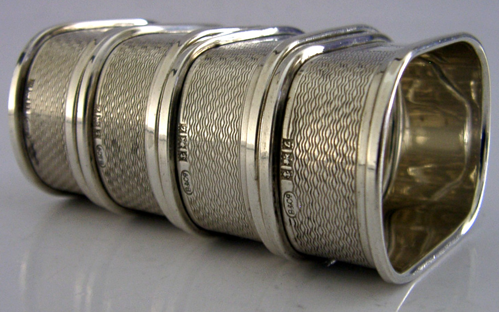 FOUR ENGLISH SOLID STERLING SILVER ENGINE TURNED NAPKIN RINGS 1959/60