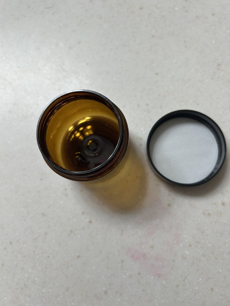 Small brown translucent plastic jars with lids