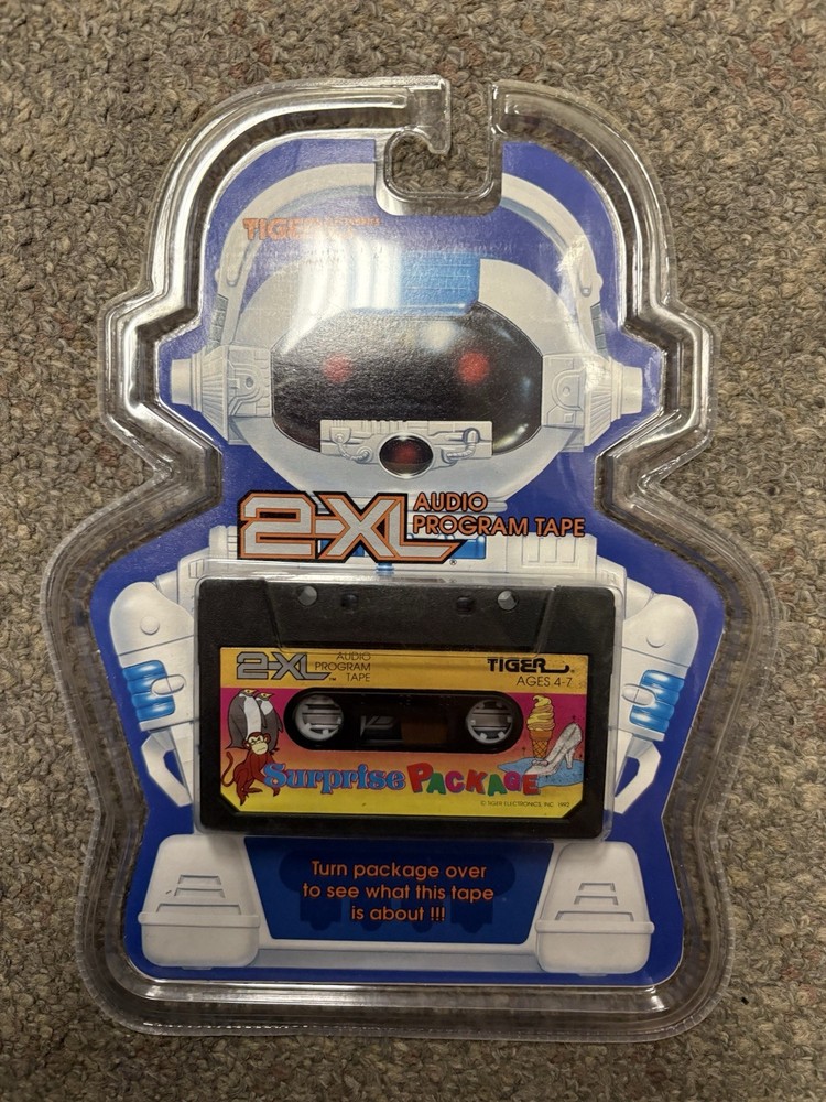 + Tiger Electronics 1992 2-XL Robot Surprise Package Audio Program Tape NIP
