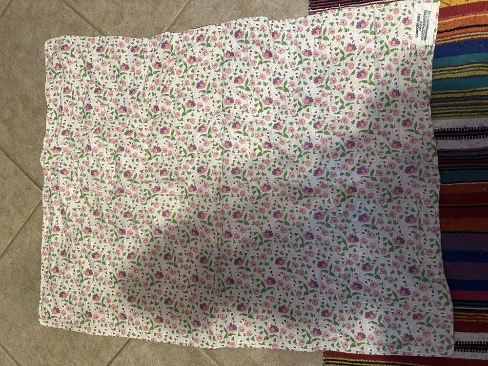 Handmade floral diamond pattern quilt with a multi-layered border.