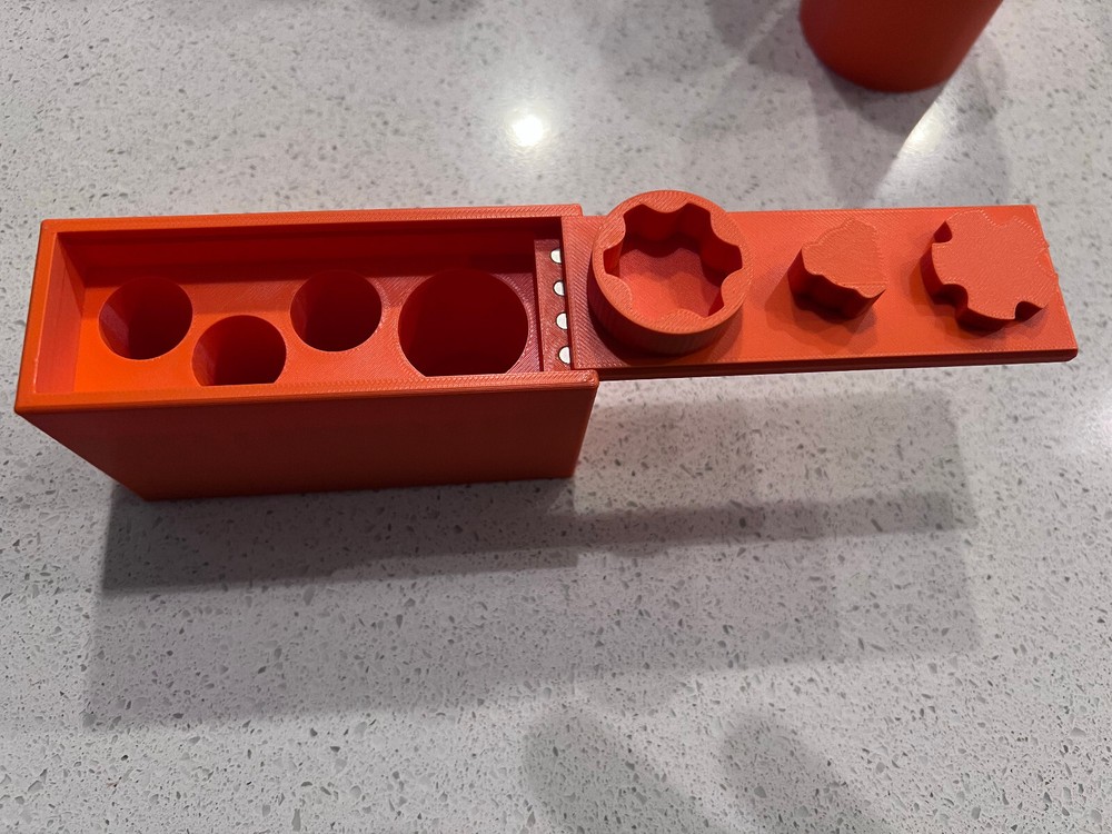 Rugged Obsidian piston/booster storage case and multi-tool