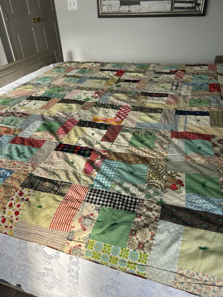 Handmade patchwork quilt with mixed fabric patterns