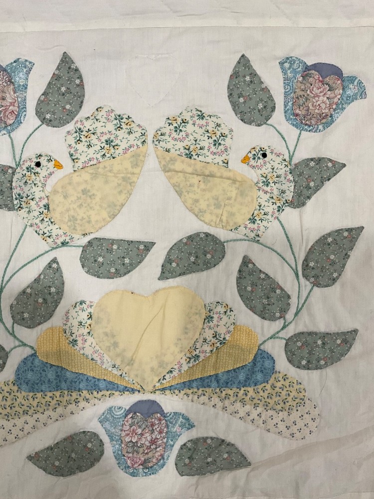 Vintage handmade quilt with birds
