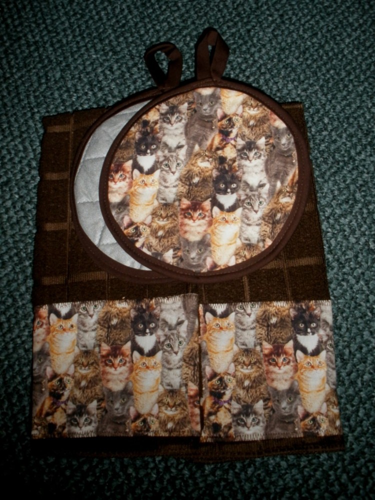 Cats packed kitchen towels and potholders