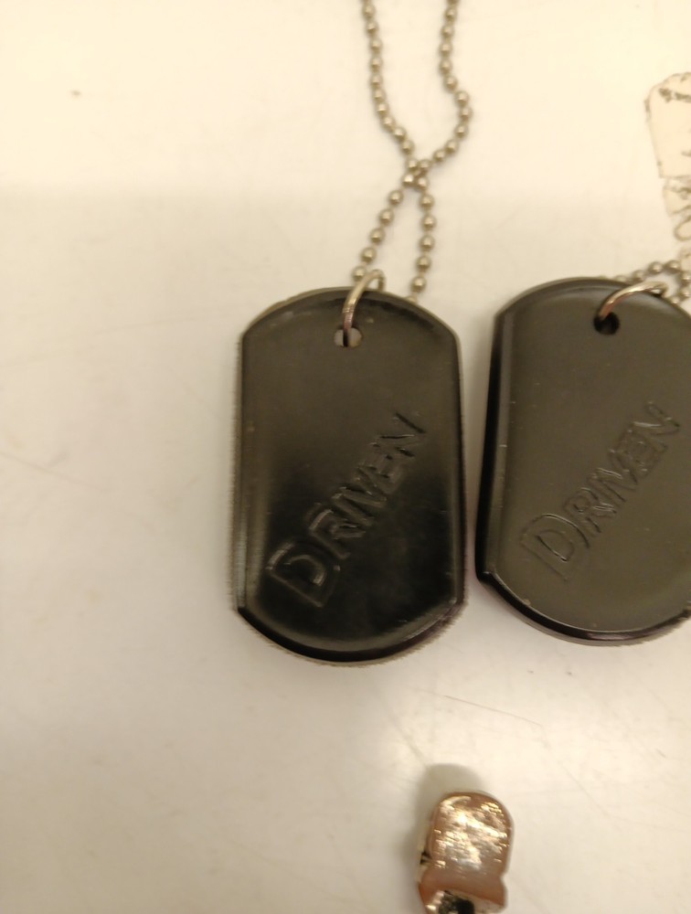 Two Driven Skull Dog Tags And Miniature Skull