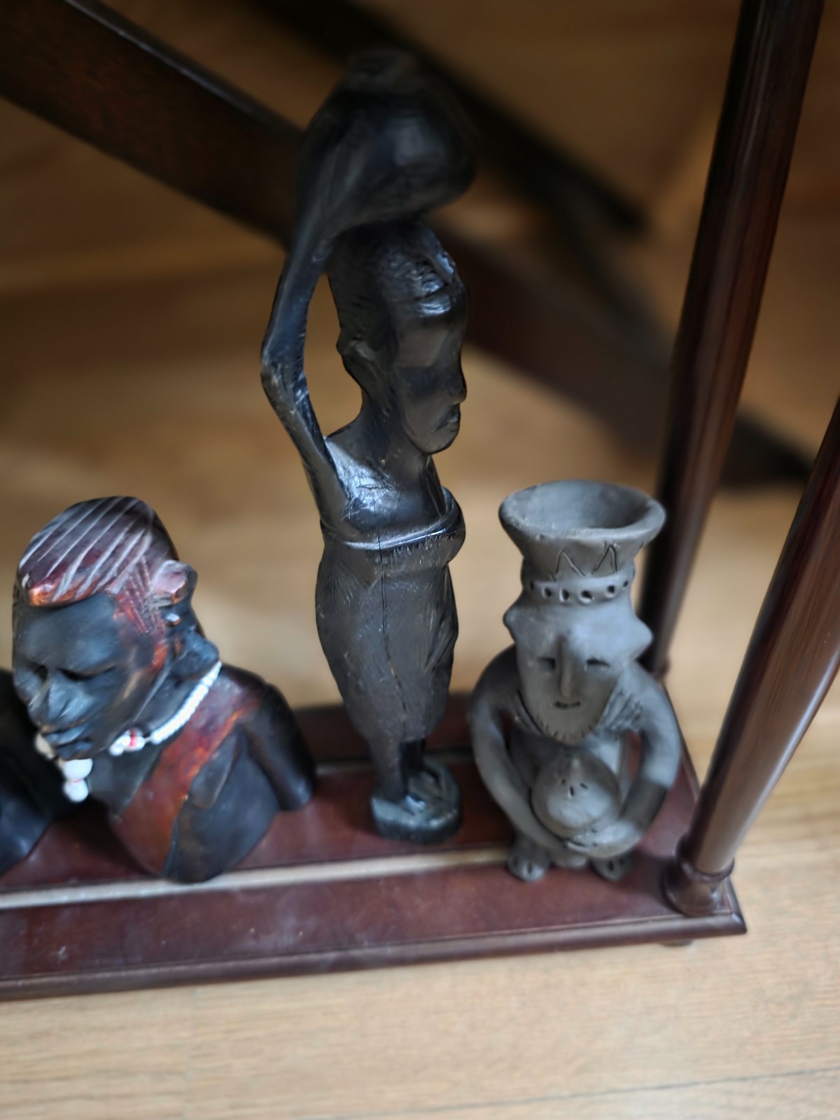 Set of carved statues from black wood, stone, bronze.