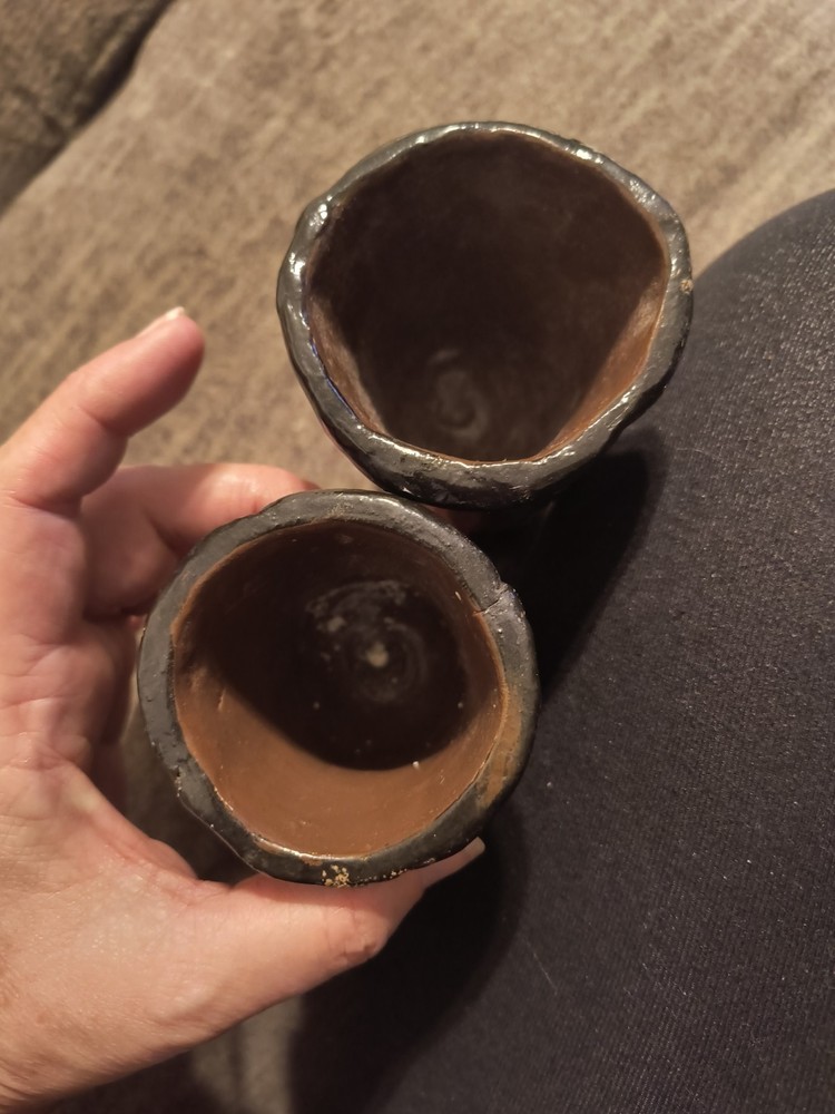 These items are handcrafted ceramic face vases or pots