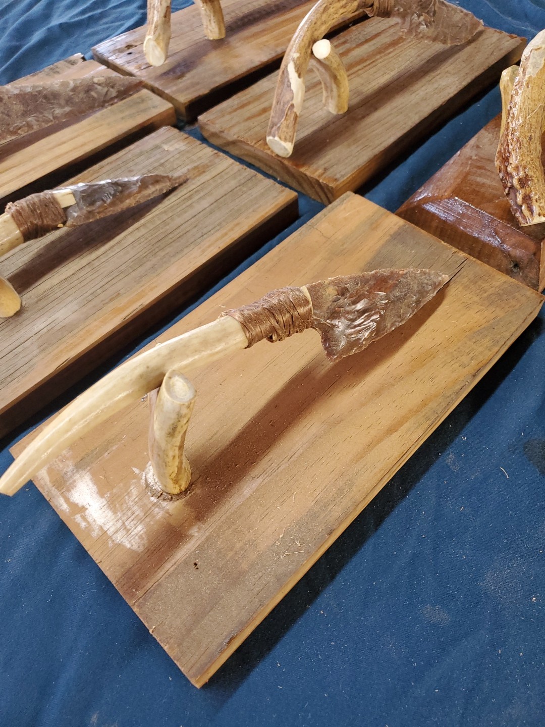 Flint Knapped Stone Arrowhead Blade Knife with Deer Antler Handle on Wood Stand