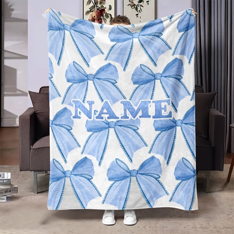 Customizable light blue flannel blanket with name and bow pattern♢