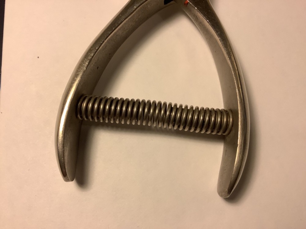 A.F. & Co. hole punch with spring handle action and adjustable punch depth guide