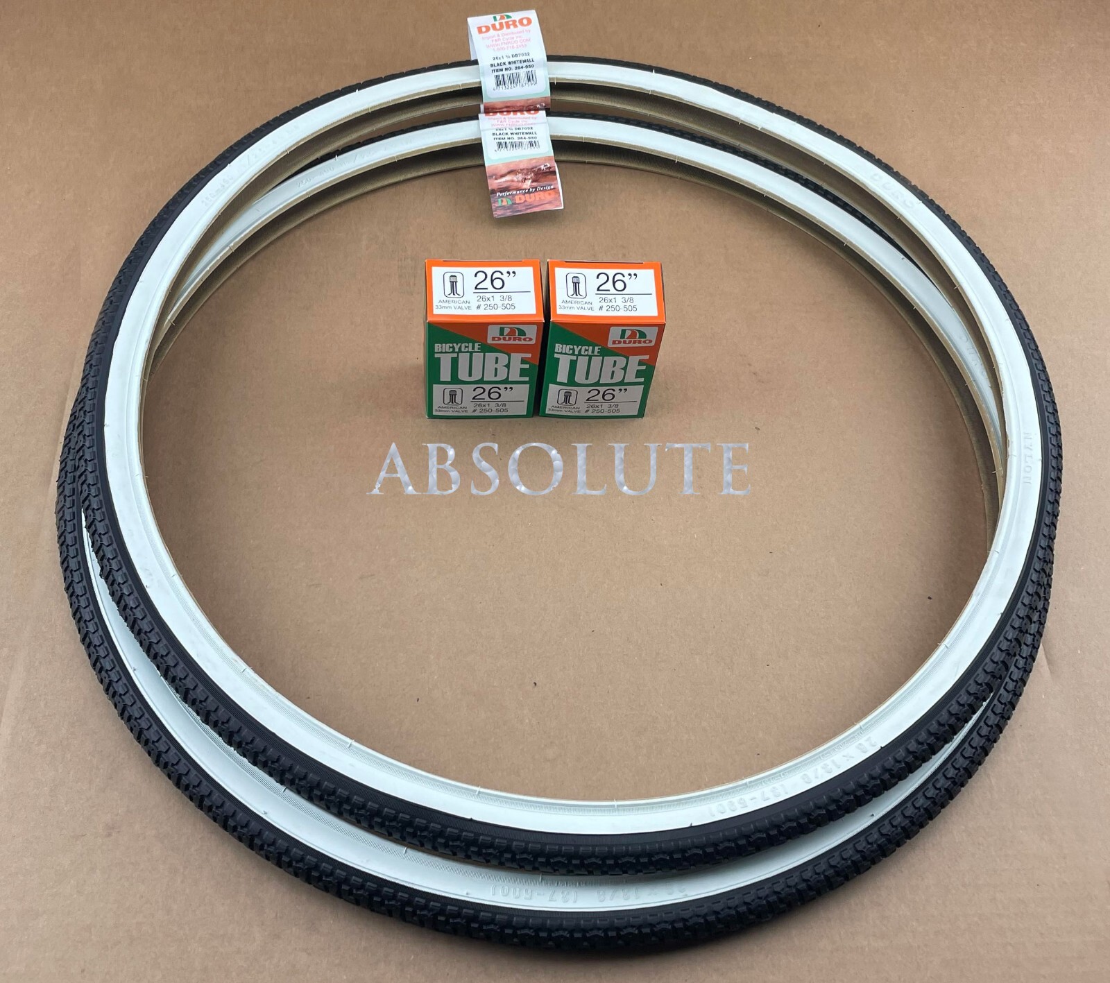PAIR OF WHITEWALL BICYCLE DURO TIRES W/ TUBES IN 26 X 1 3/8 SEMI-SLICK TREAD.