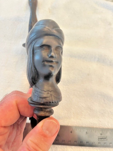 Antique figural hook with a man's face