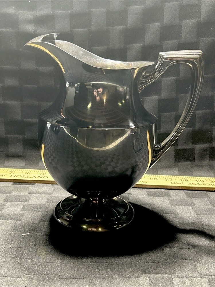 Vintage crescent silver plated water pitcher with ice lip