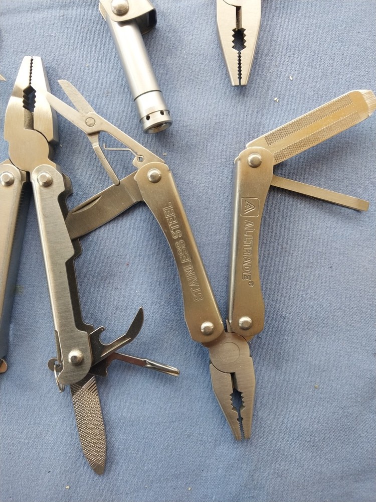 4 small multitudes with pliers knife scissors screwdriver's