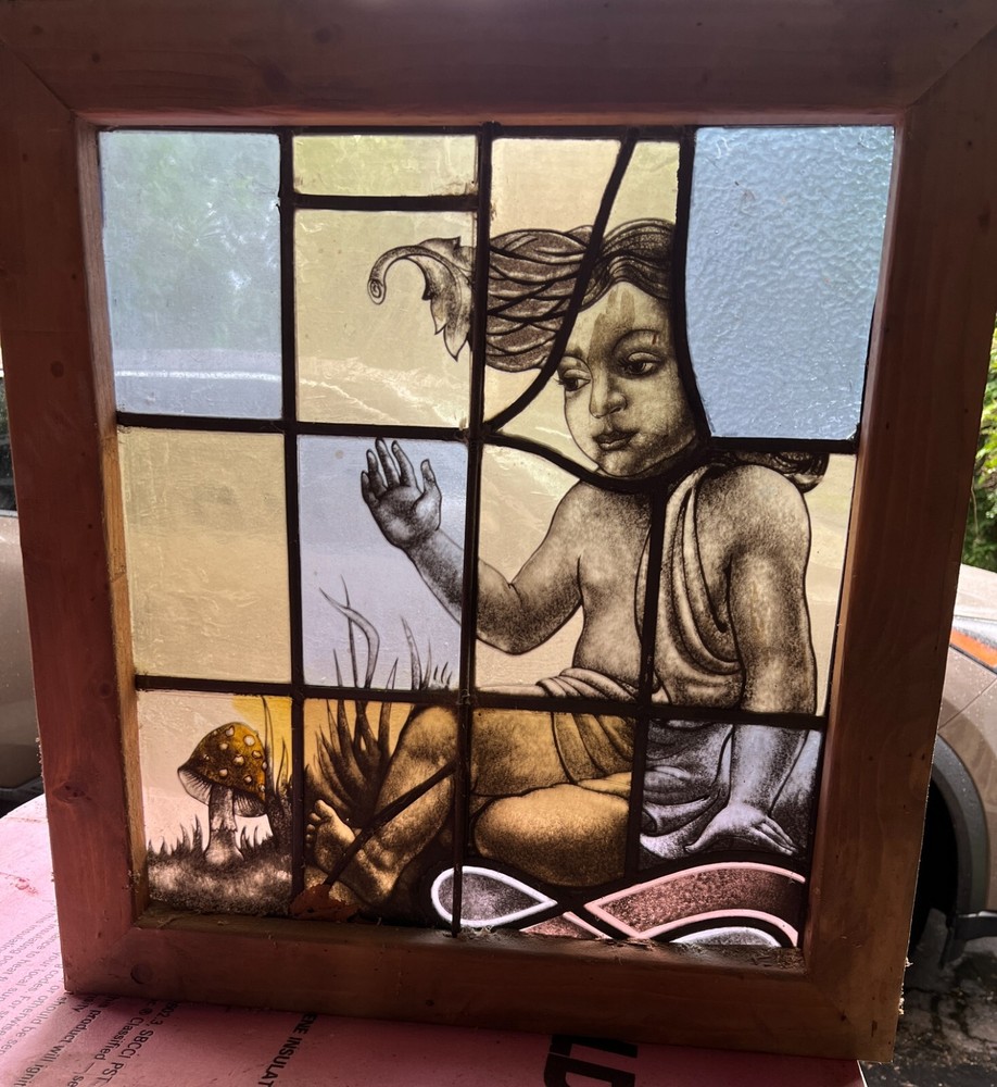 Interesting cherub character stained glass window