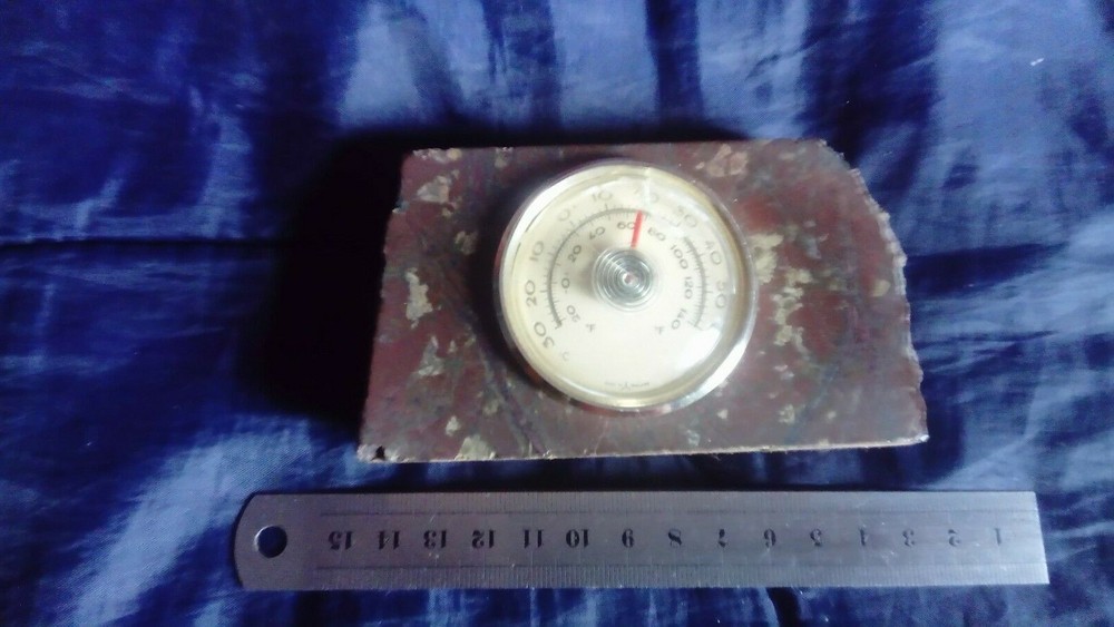 Vintage thermometer mounted in natural stone