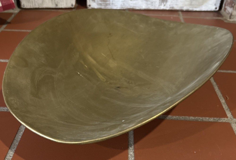 A large, antique solid brass mercantile scale pan.
