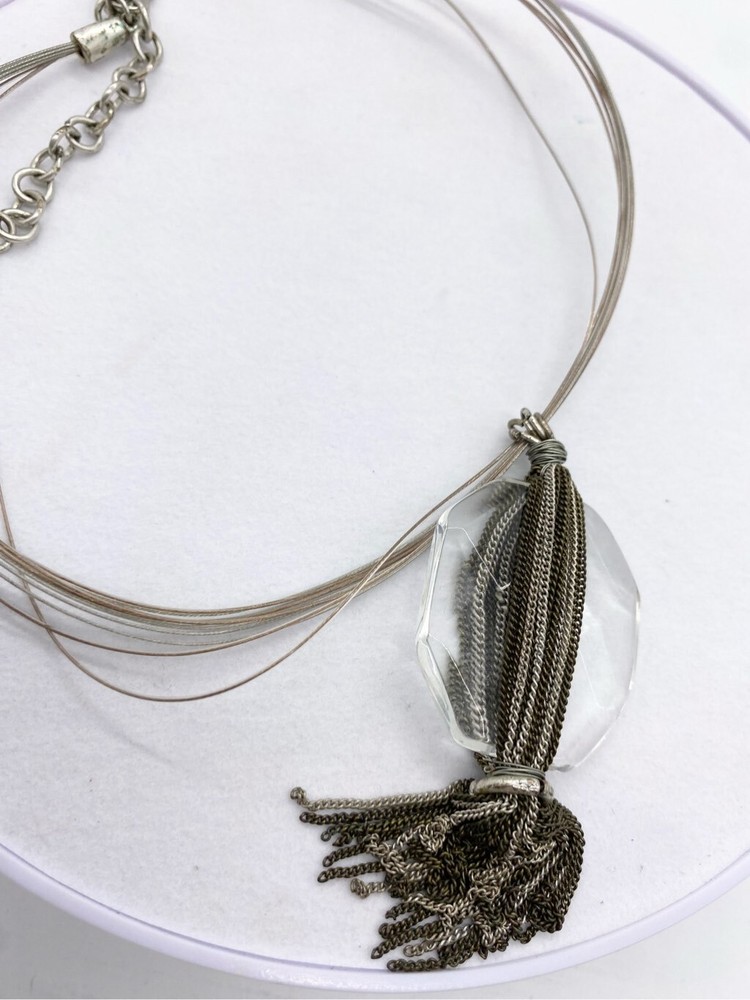 Clear large glass stone with multi layered chain silver tassel