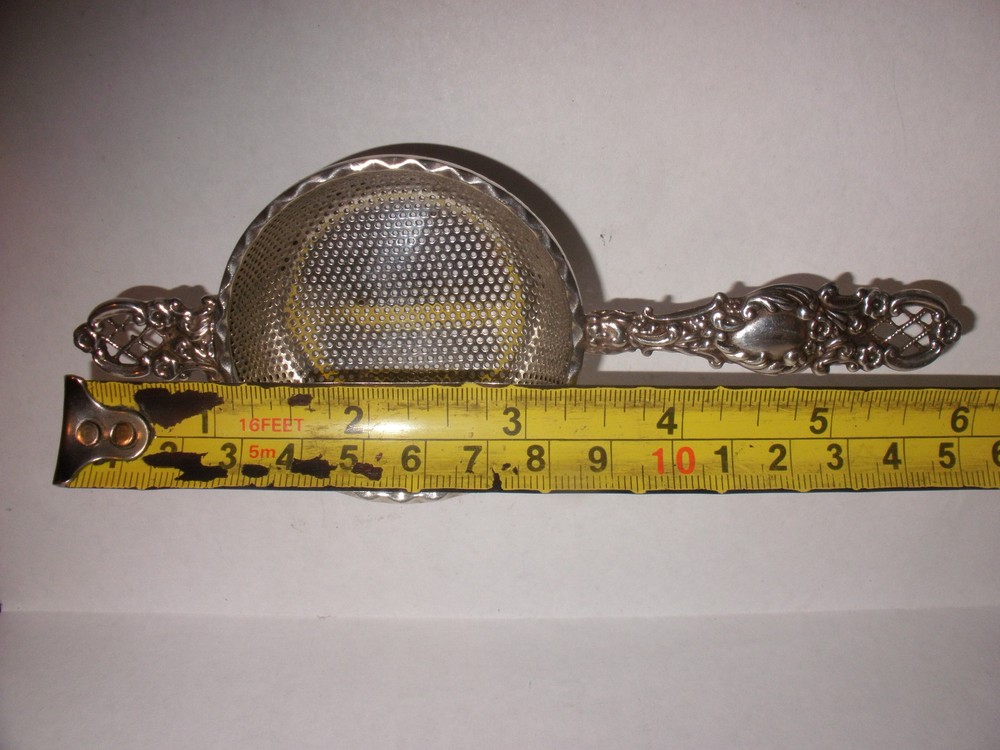 Nice Antique Continental silver flowers repousse tea strainer