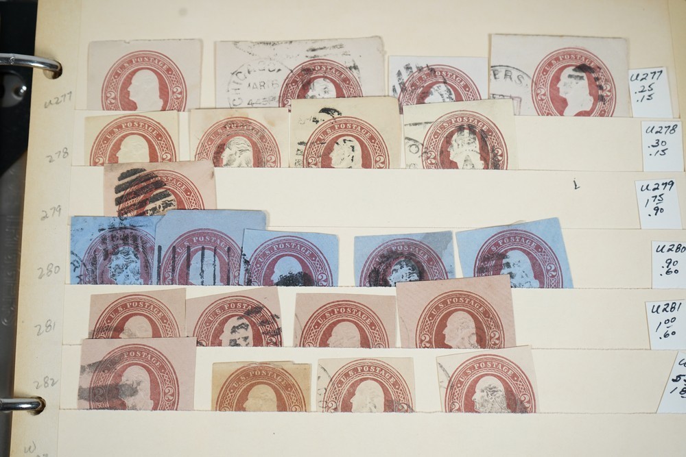 US COLLECTION OF 1,200+ STATIONERY CUT SQUARE STAMPS STORED IN STOCKBOOK