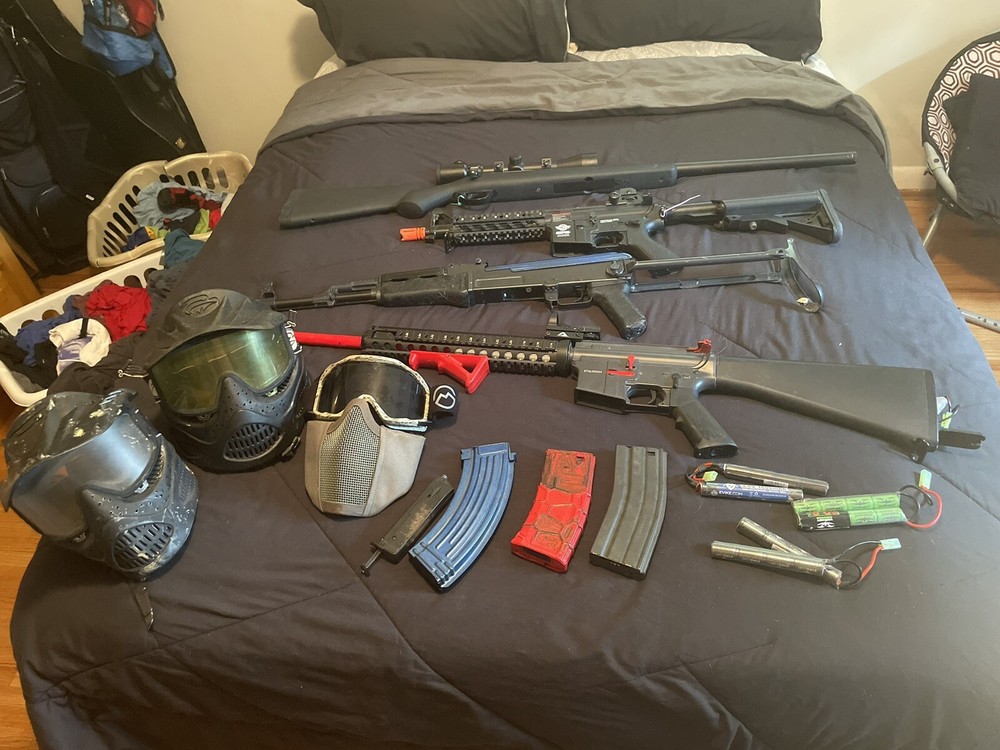 assorted air soft rifles and gear