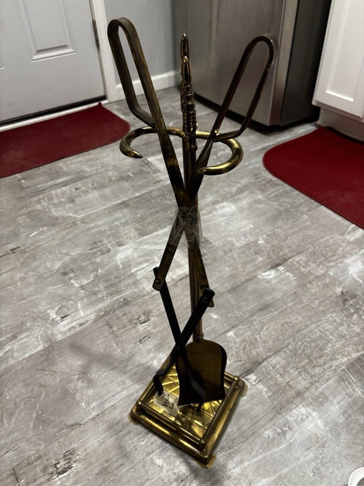 This item is a vintage brass fireplace tool set, typically featuring tools