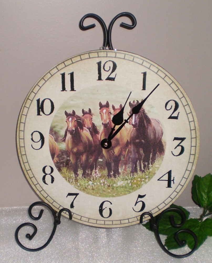 ~~GALLOPING THOROUGHBRED HORSES CLOCK MOUNTED ON BLACK SCROLL STAND~~