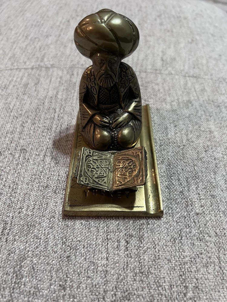 A vintage brass middle eastern scholar sculpture.