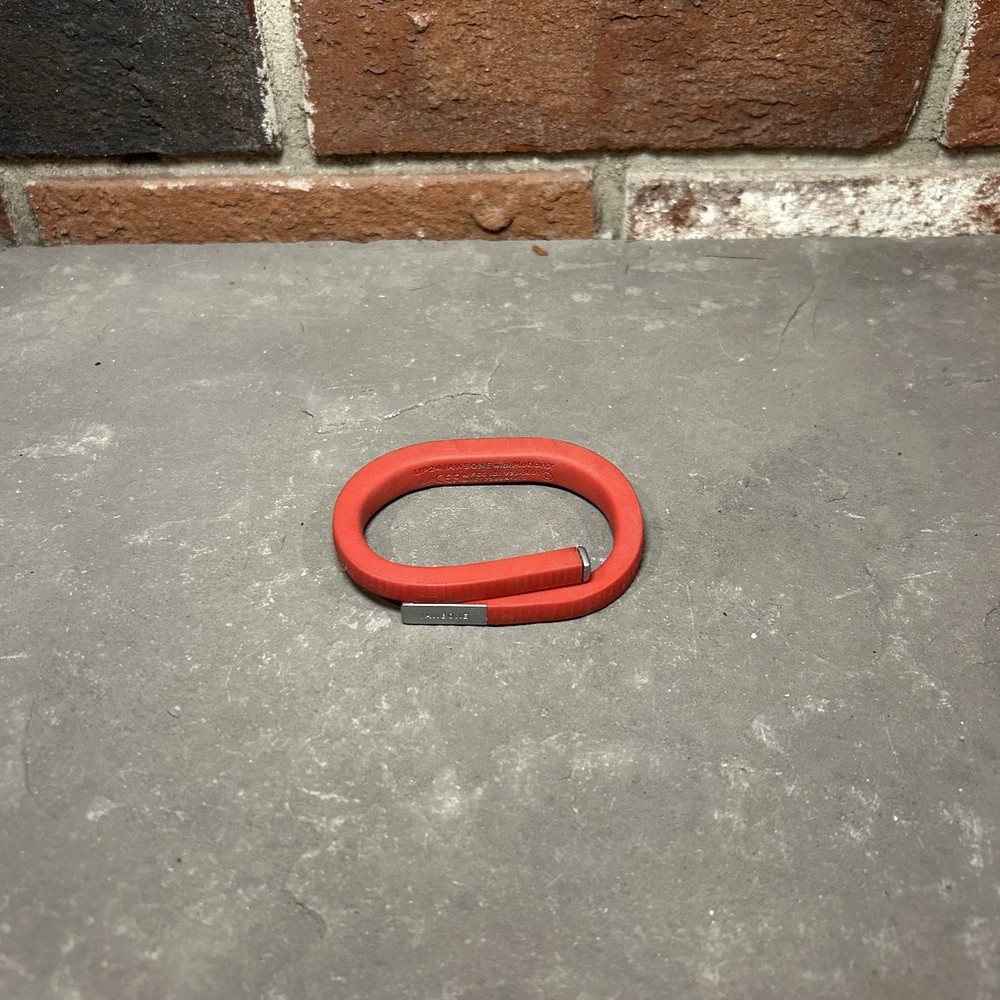 Jawbone UP24 Activity Tracker along with its charging cable Red