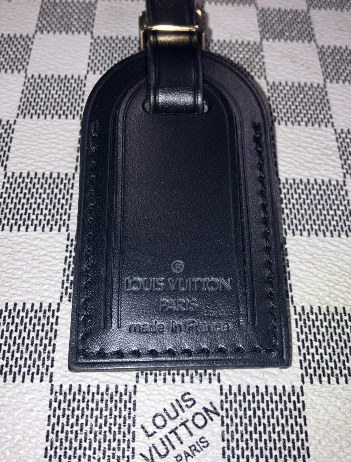 Authentic Louis Vuitton small Black W/ Gold Hardware name tag.