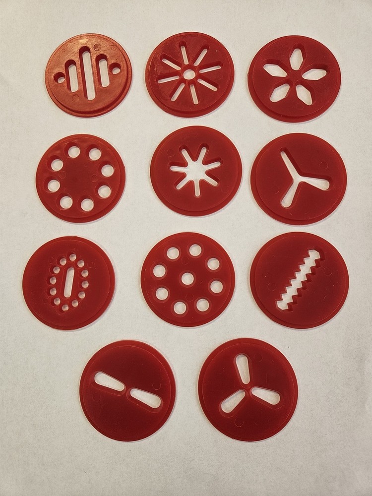 11 RED PLASTIC DISCS FROM A WHITE WILTON COOKIE PRESS