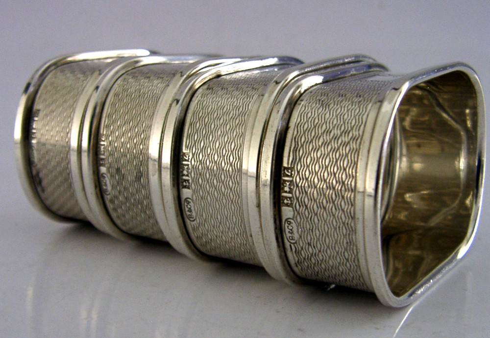FOUR ENGLISH SOLID STERLING SILVER ENGINE TURNED NAPKIN RINGS 1959/60