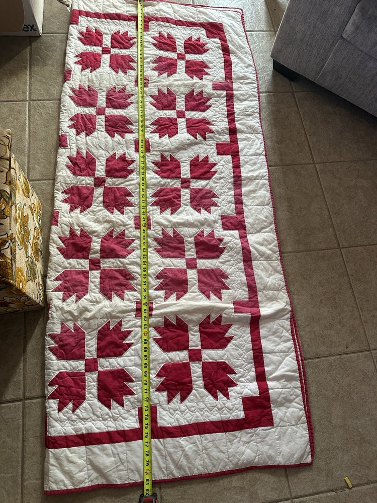 Cutters handmade red and white "Bear Paw" pattern quilt.