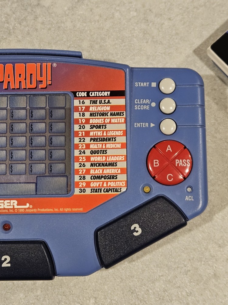 Tiger Electronics Jeopardy Hand Held Game 1995 with Answer Question Book