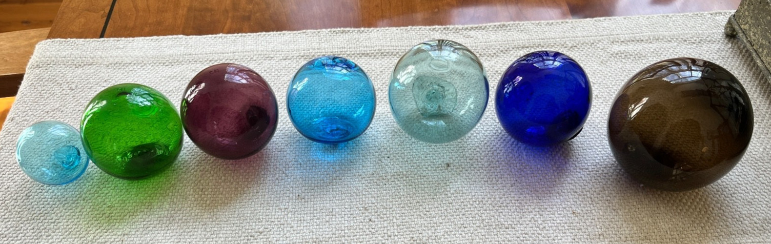 Lot of 7 vintage hand blown glass fishing floats or balls.