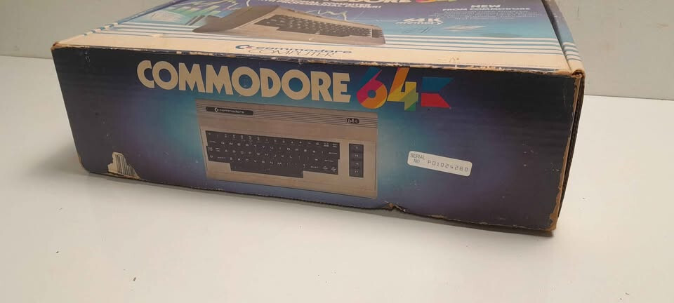 Vintage Commodore 64 computer in box, manuals and programs package