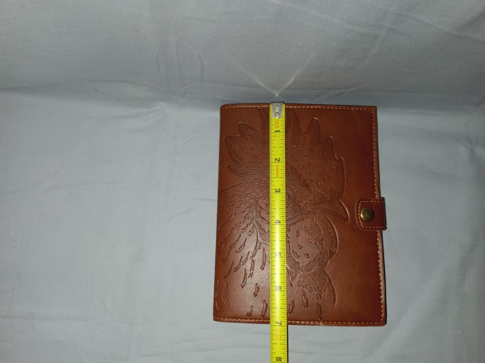 brown leather journal cover with an embossed rooster design. 