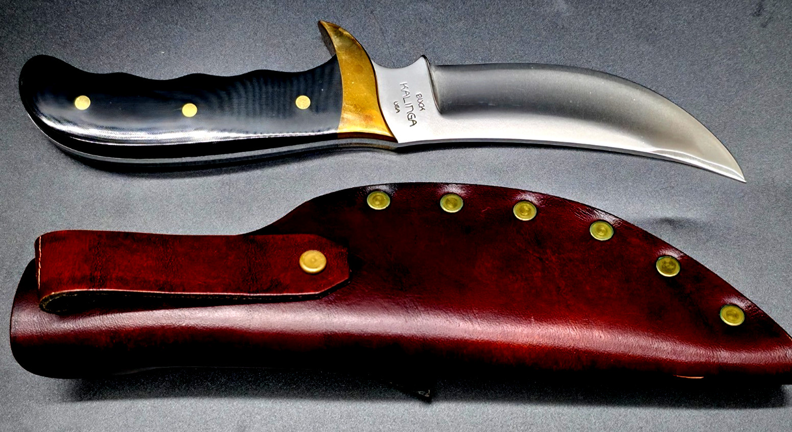 Buck Kalinga knife with black handle and brown leather sheath